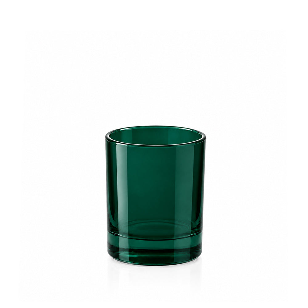 A dark green translucent glass tumbler with a thick base, shown on a clean white background with a soft reflection underneath.