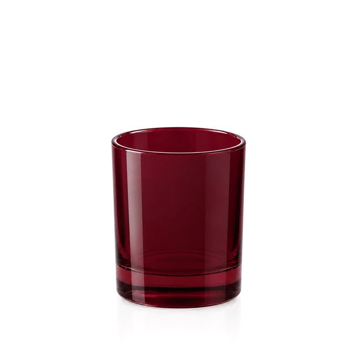 A single dark red glass tumbler with a thick base, photographed on a clean white background.